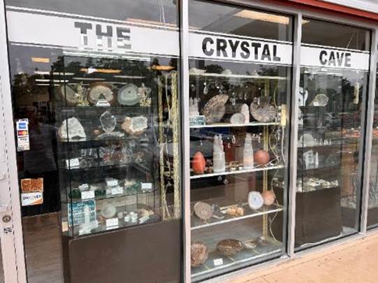 A store front with a display of rocks and minerals

Description automatically generated